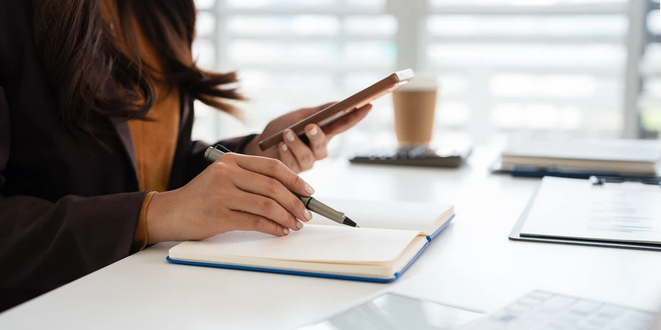 Réunion d'affaires dans un bureau moderne avec deux professionnels examinant des documents contractuels